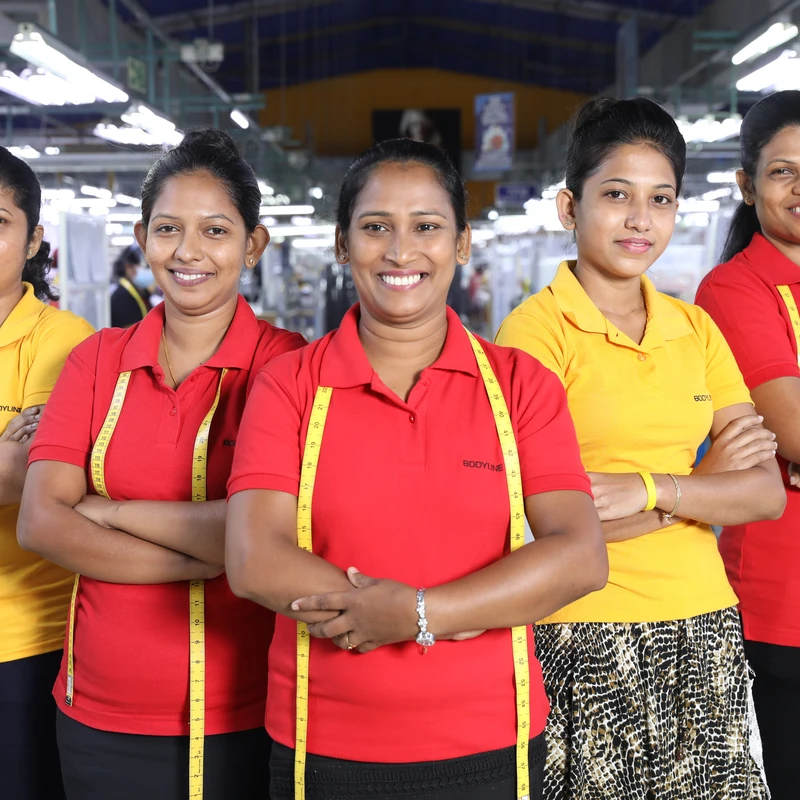 MAS team members in red MAS polos on the production floor