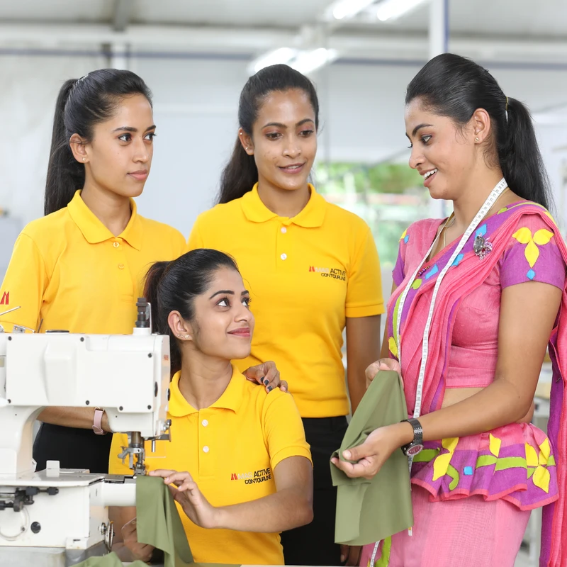 MAS operators in yellow polos at a sewing machine