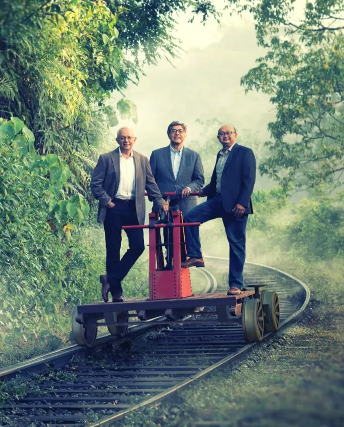 MAS founders Mahesh, Ajay and Sharad Amalean standing on a railway trolley