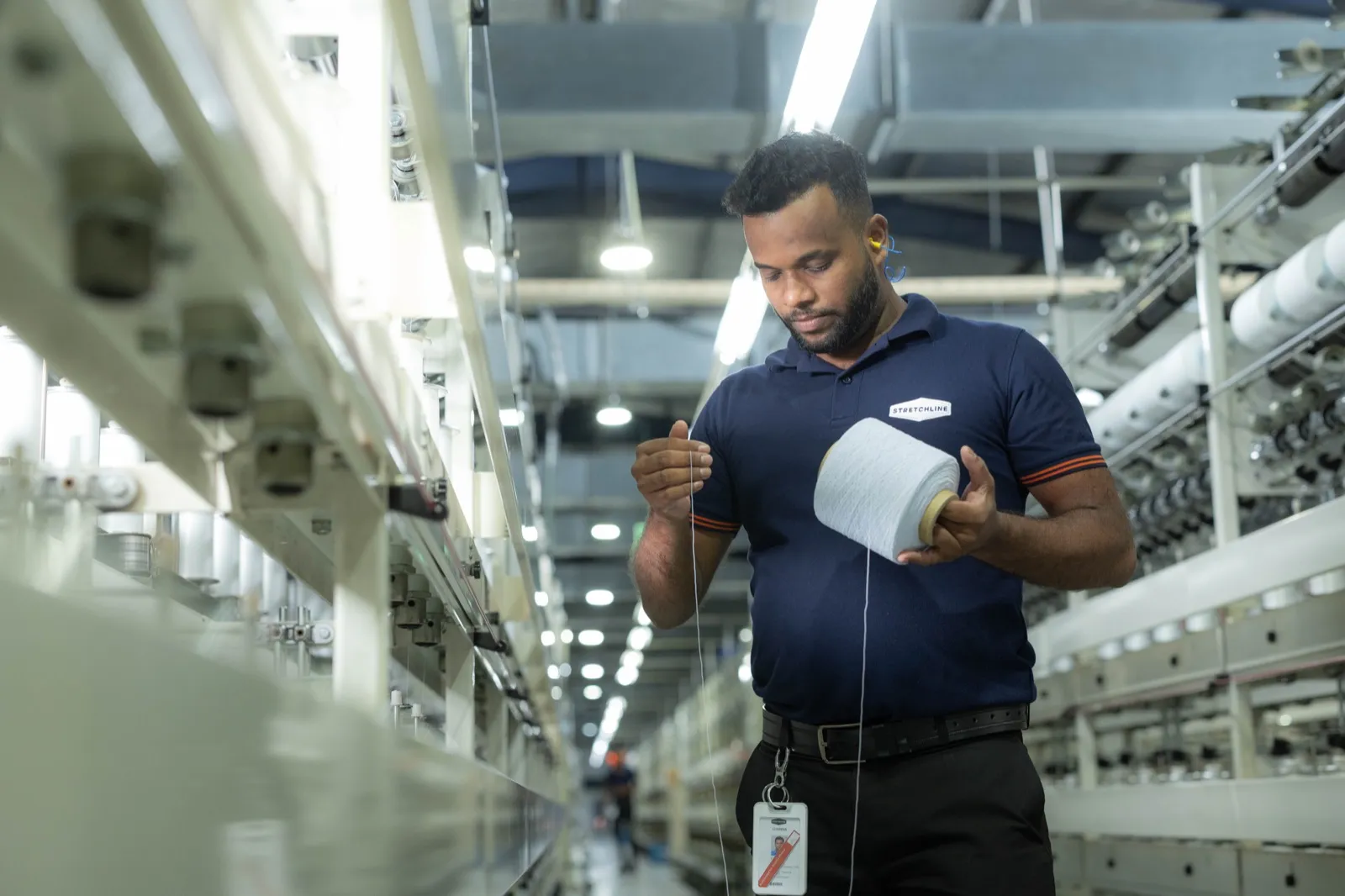 MAS team member inspecting yarn on the production floor
